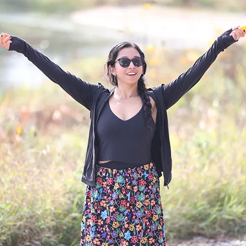 woman standing with her arms up